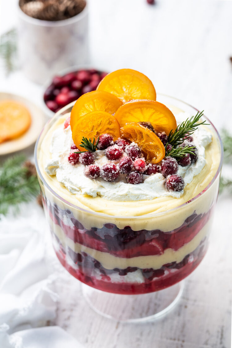 Cranberry Trifle in a trifle bowl, topped with sugared cranberries and candied oranges.