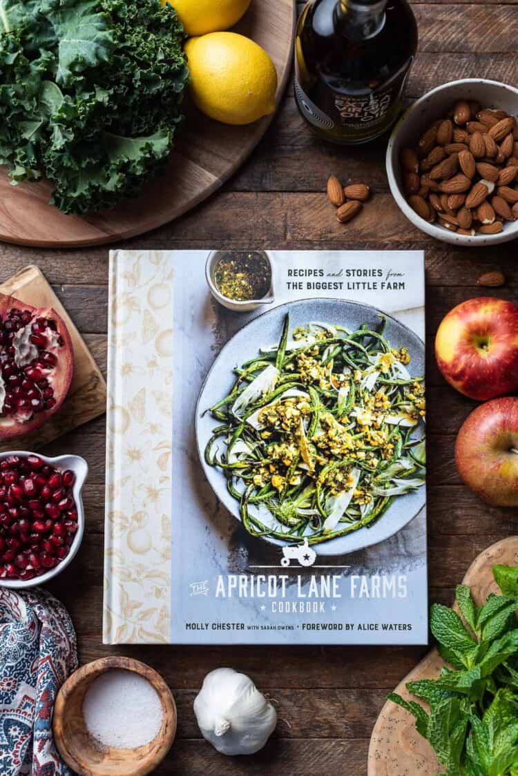 The Apricot Lane Farms Cookbook on a wooden table.