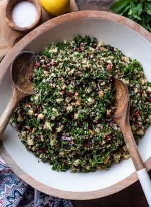 Kale Tabbouleh with Apples, Almonds, and Pomegranate in a salad bowl.