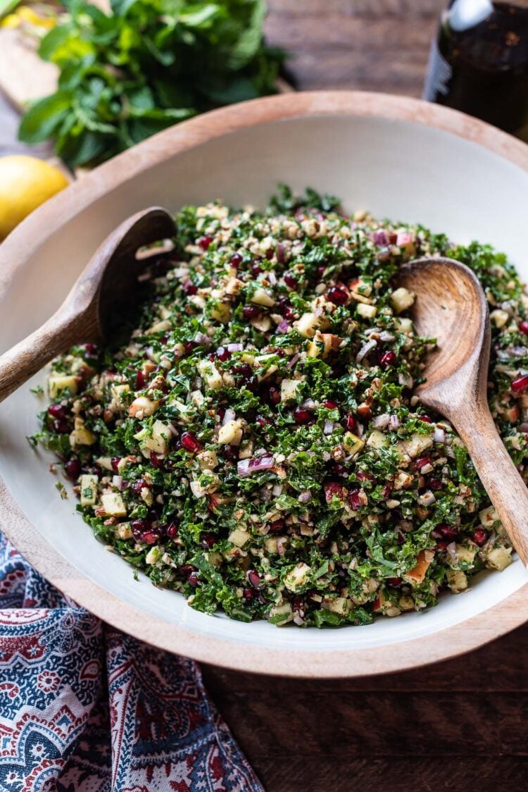 Kale Tabbouleh with Apples, Almonds, and Pomegranate in a salad bowl.