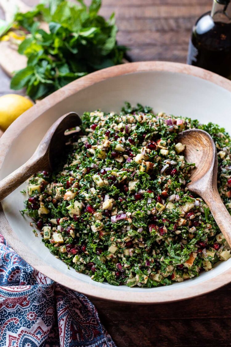 Kale Tabbouleh with Apples, Almonds, and Pomegranate in a salad bowl.