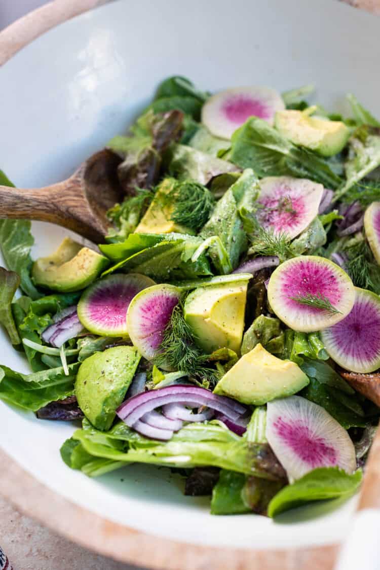 Lettuce Salad with Mayonnaise Dressing, watermelon radishes, avocados, red onion, and dill.