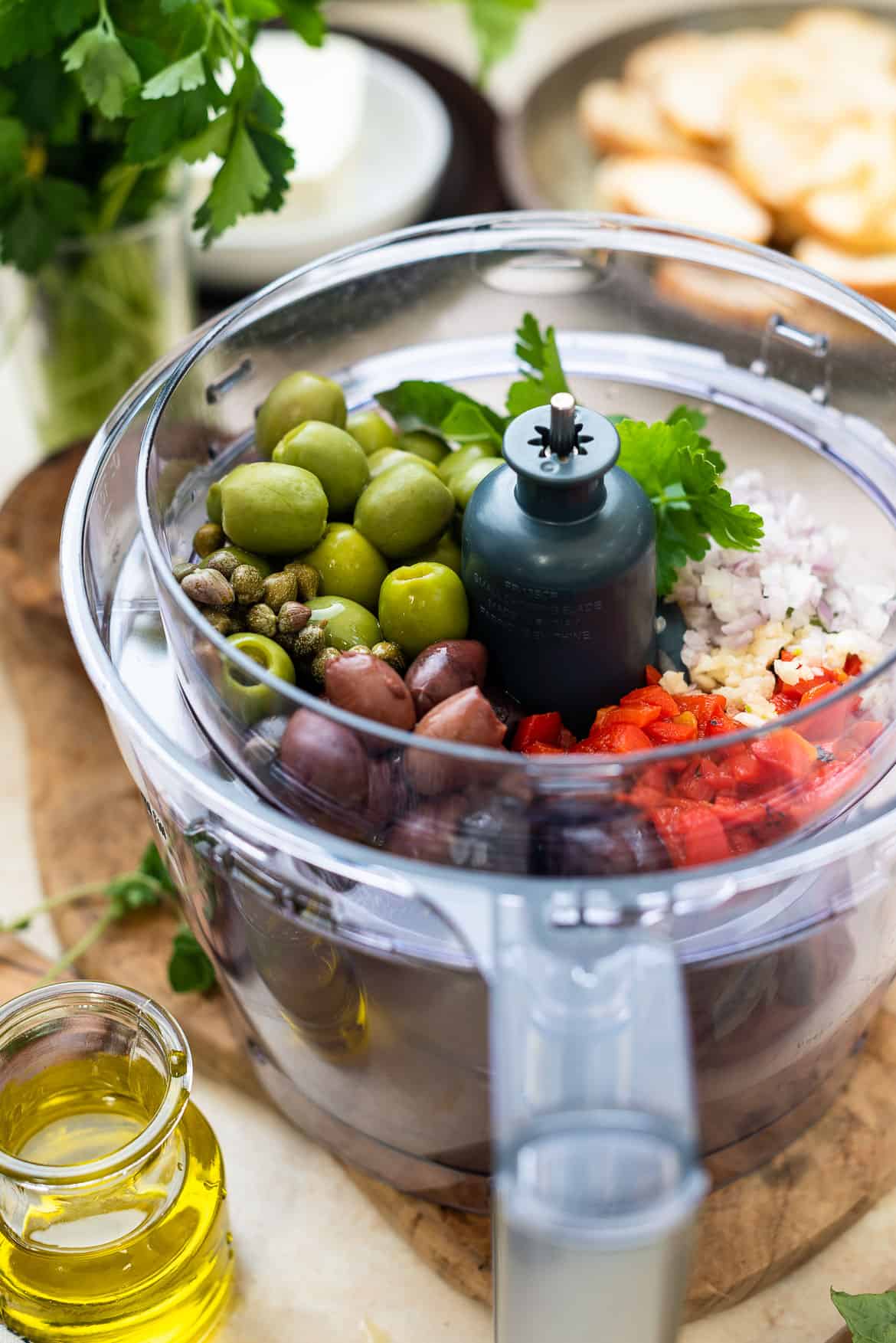 Olive bruschetta ingredients in a food processor.