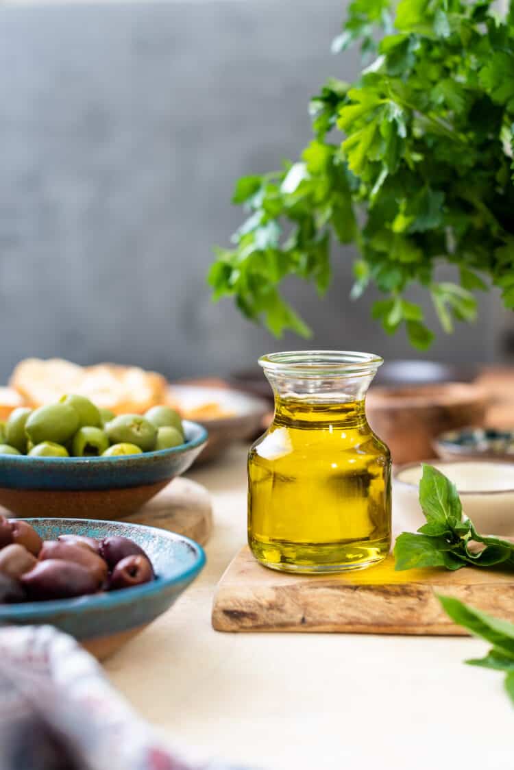 A small glass jar of olive oil.