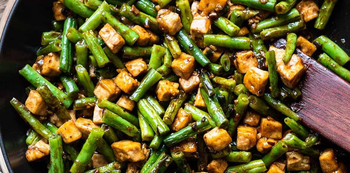 Stir-fried String Beans With Tofu in Black Bean Sauce in a saute pan.