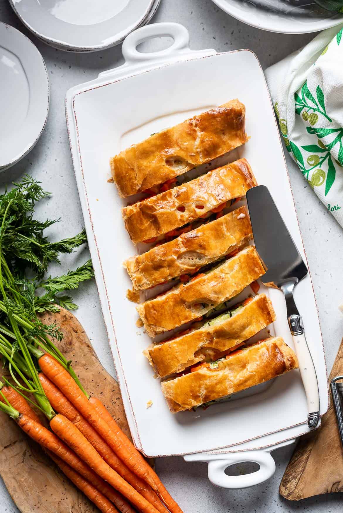 Carrot and Zucchini Strudel sliced on a serving tray.