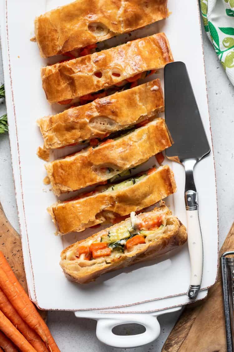 Carrot and Zucchini Strudel sliced on a serving tray.