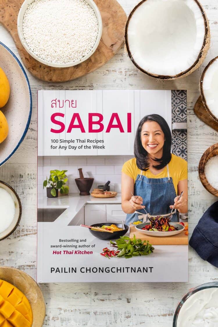 Sabai: 100 Simple Thai Recipes for Any Day of the Week cookbook on a white table.
