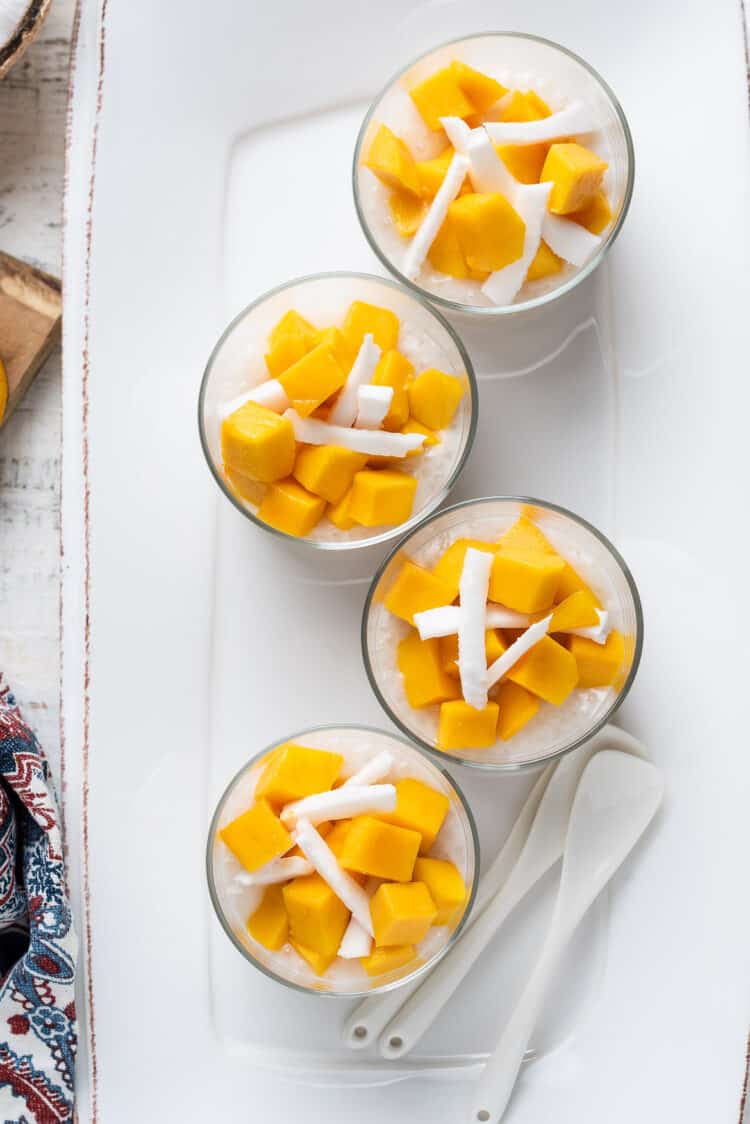 Mango Coconut Tapioca Pudding cups served in glass cups.