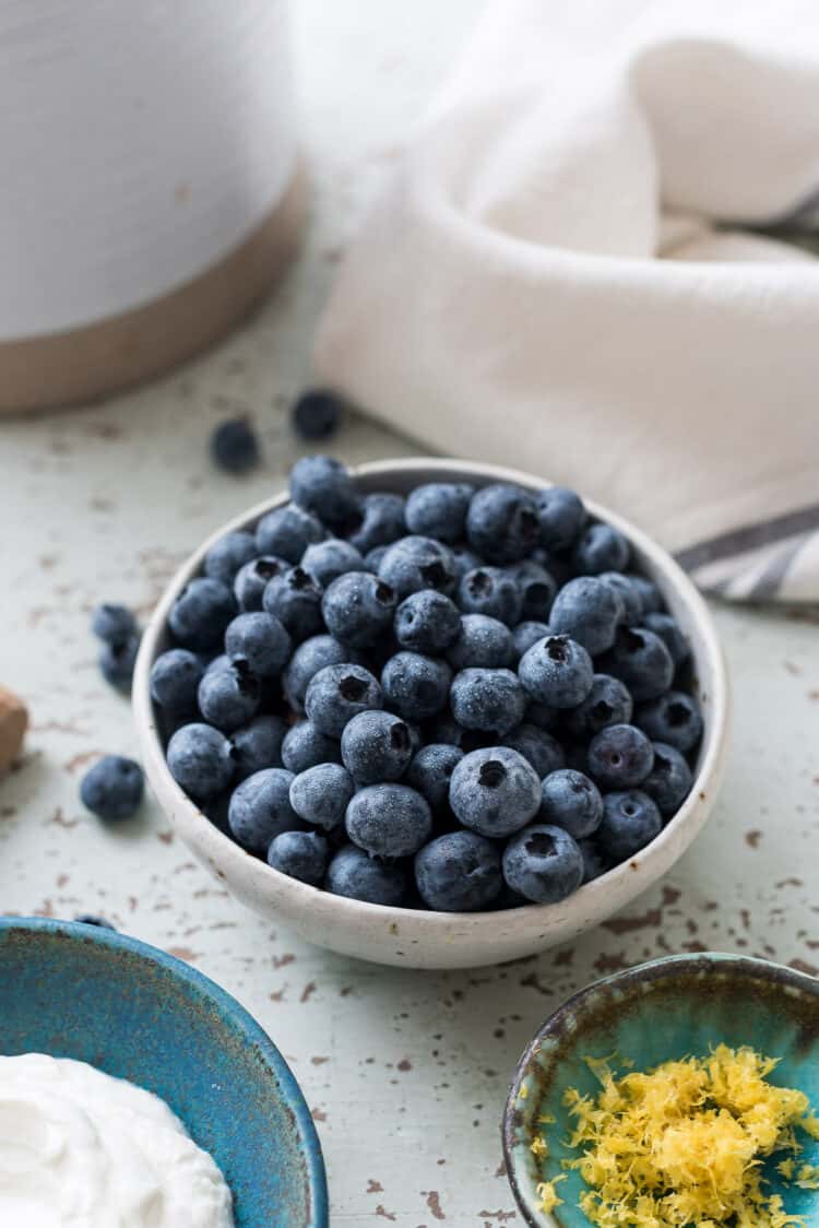 Blueberries in a white bowl for a galette.