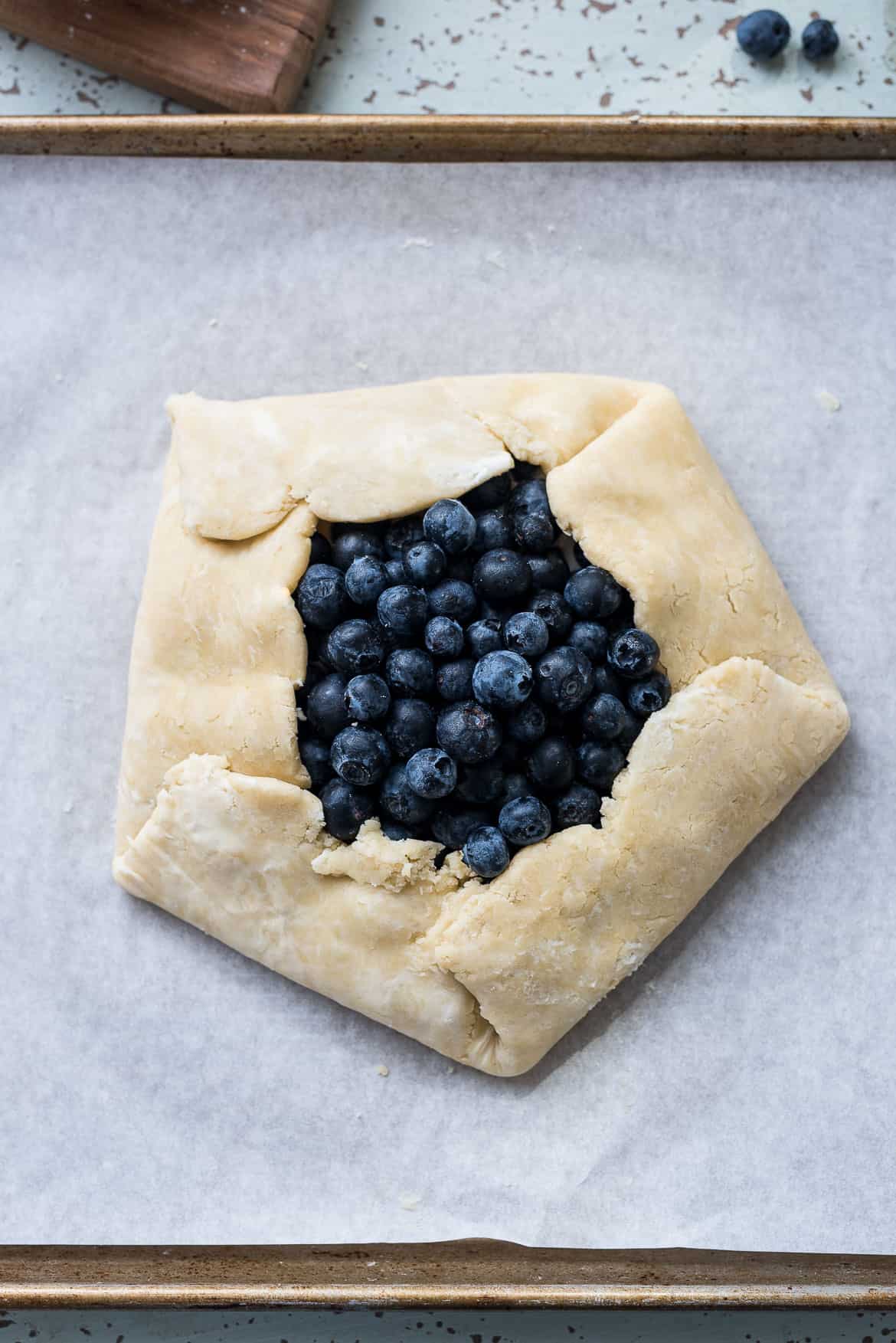 An assembled Blueberry and Greek Yogurt Breakfast Galette on a baking tray, ready for baking.