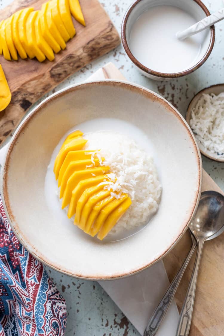 Sweet coconut sticky rice with mango and shredded coconut.