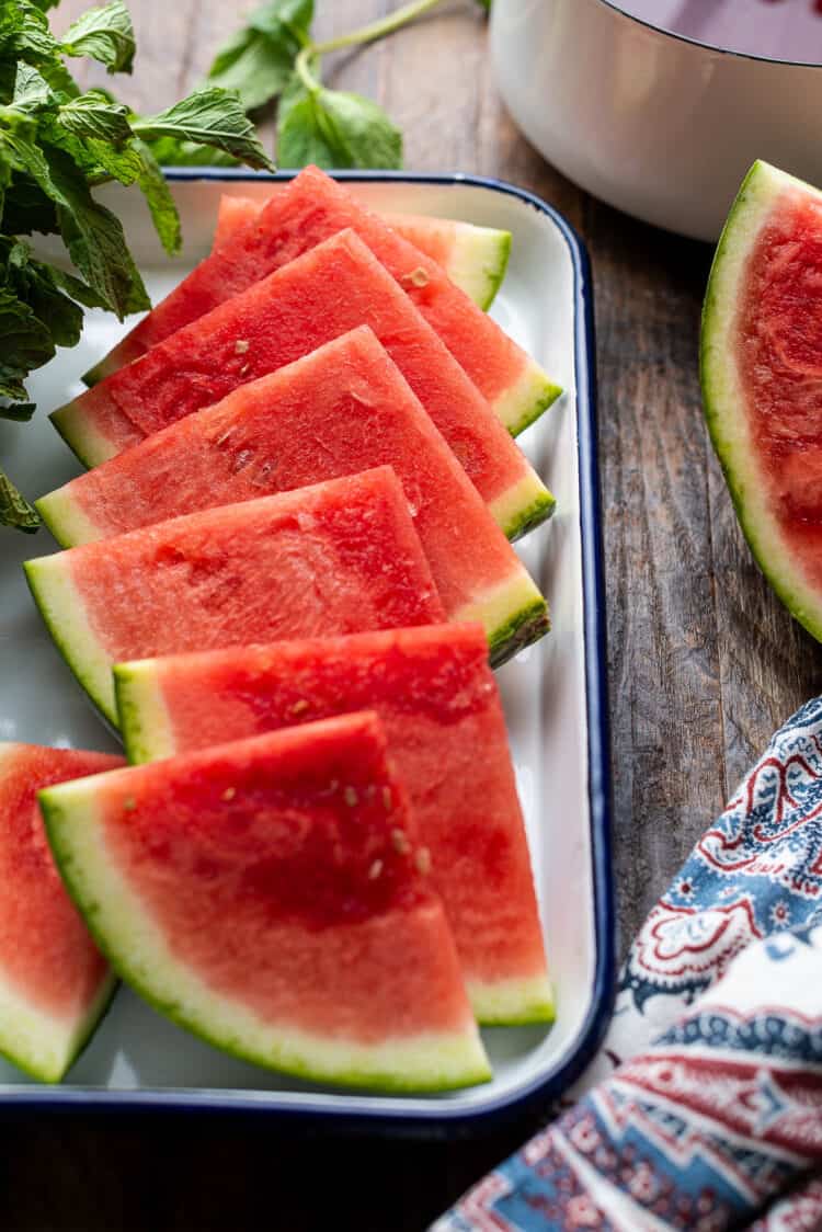 Slices of watermelon on a tray.