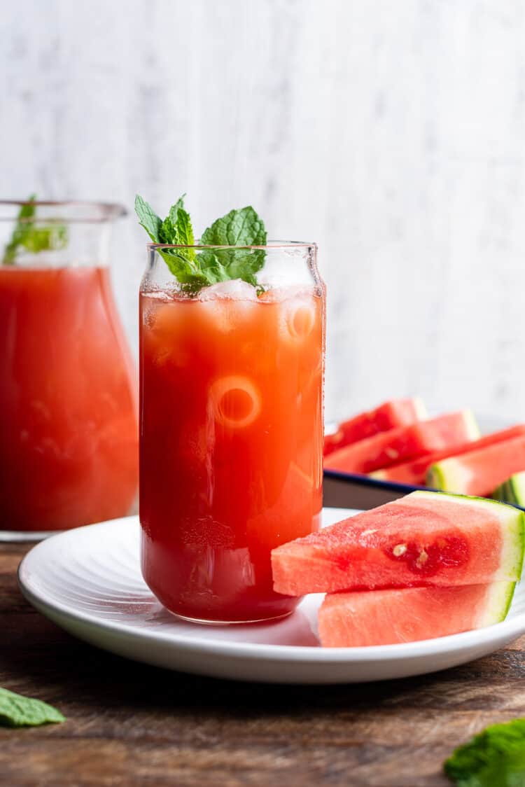 Watermelon Sweet Tea in a glass garnished with mint.