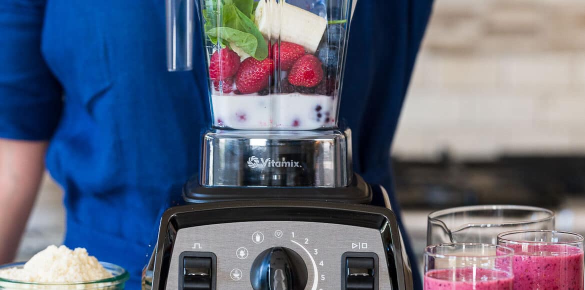 Placing ingredients in a Vitamix blender.