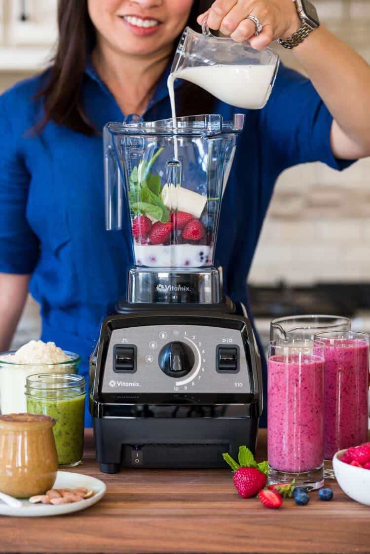 Placing ingredients in a Vitamix blender.