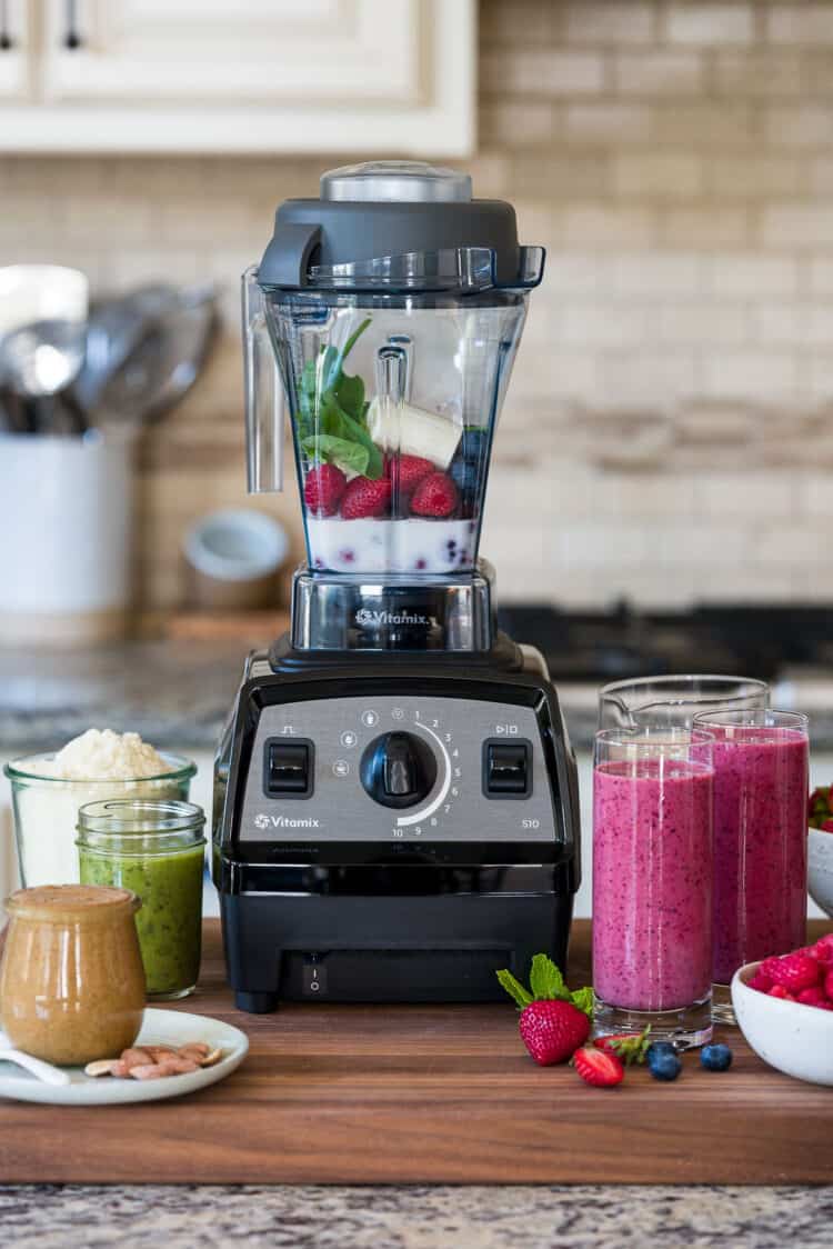 A Vitamix blender surrounded by various recipes, including smoothies, nut butters, salad dressings, and more.