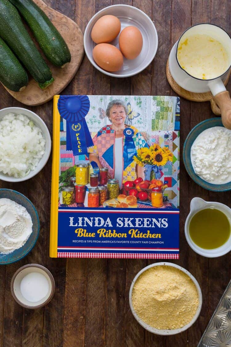 Blue Ribbon Kitchen cookbook by Linda Skeens on a wooden table.