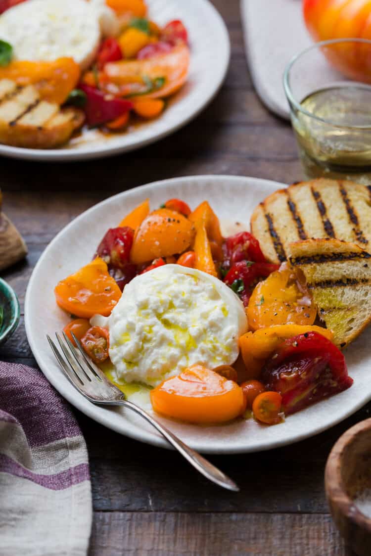 Burrata with Heirloom Tomatoes on a plate.