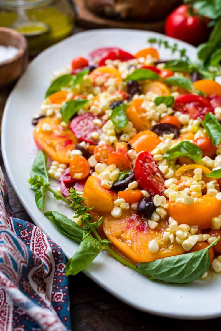 Tomato Salad with basil on a platter.