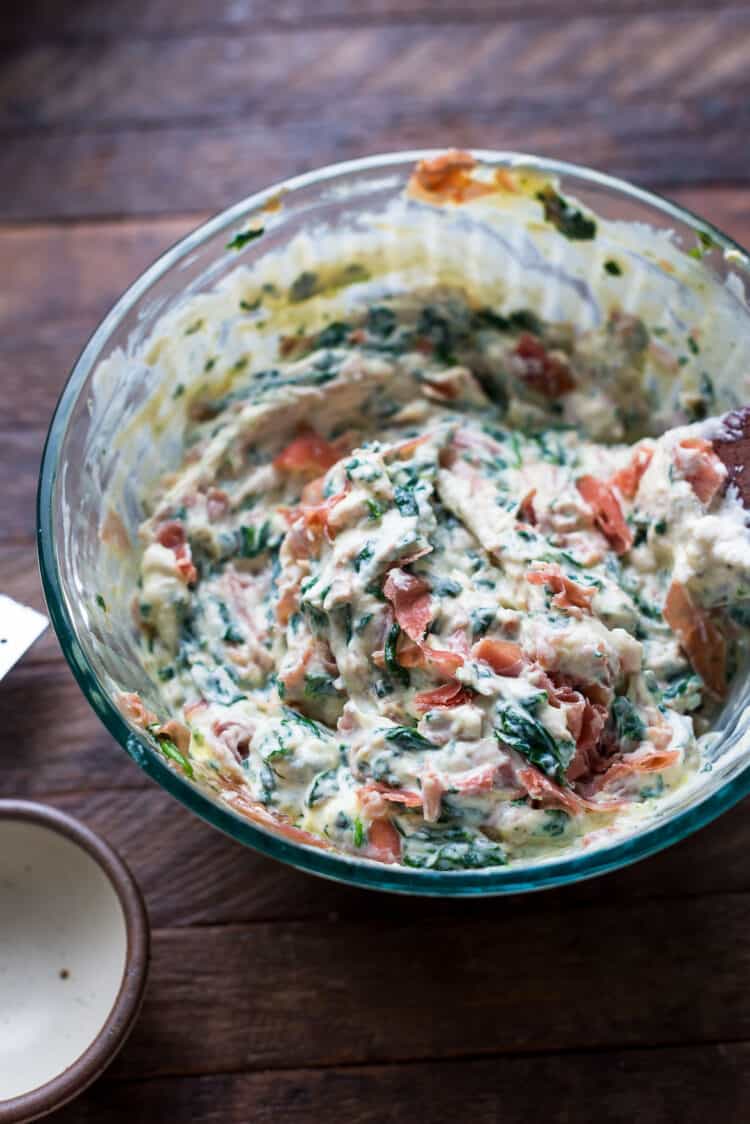 Ricotta mixture with prosciutto and spinach in a bowl.