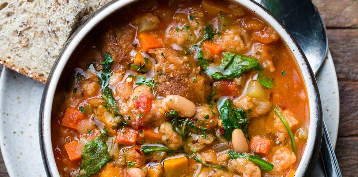 Ribollita (Tuscan-style Bread Soup) served in a soup bowl, with a side of bread.