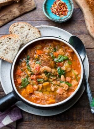 Ribollita (Tuscan-style Bread Soup) served in a soup bowl, with a side of bread.