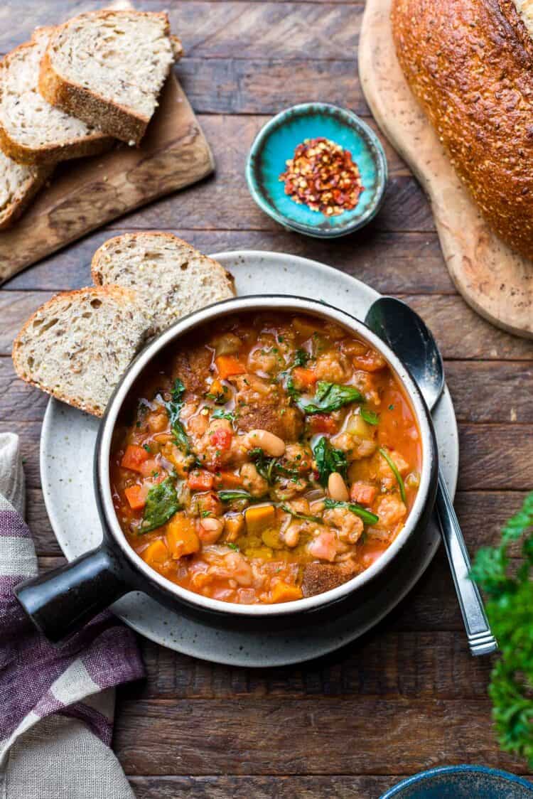 Ribollita (Tuscan-style Bread Soup) served in a soup bowl, with a side of bread.