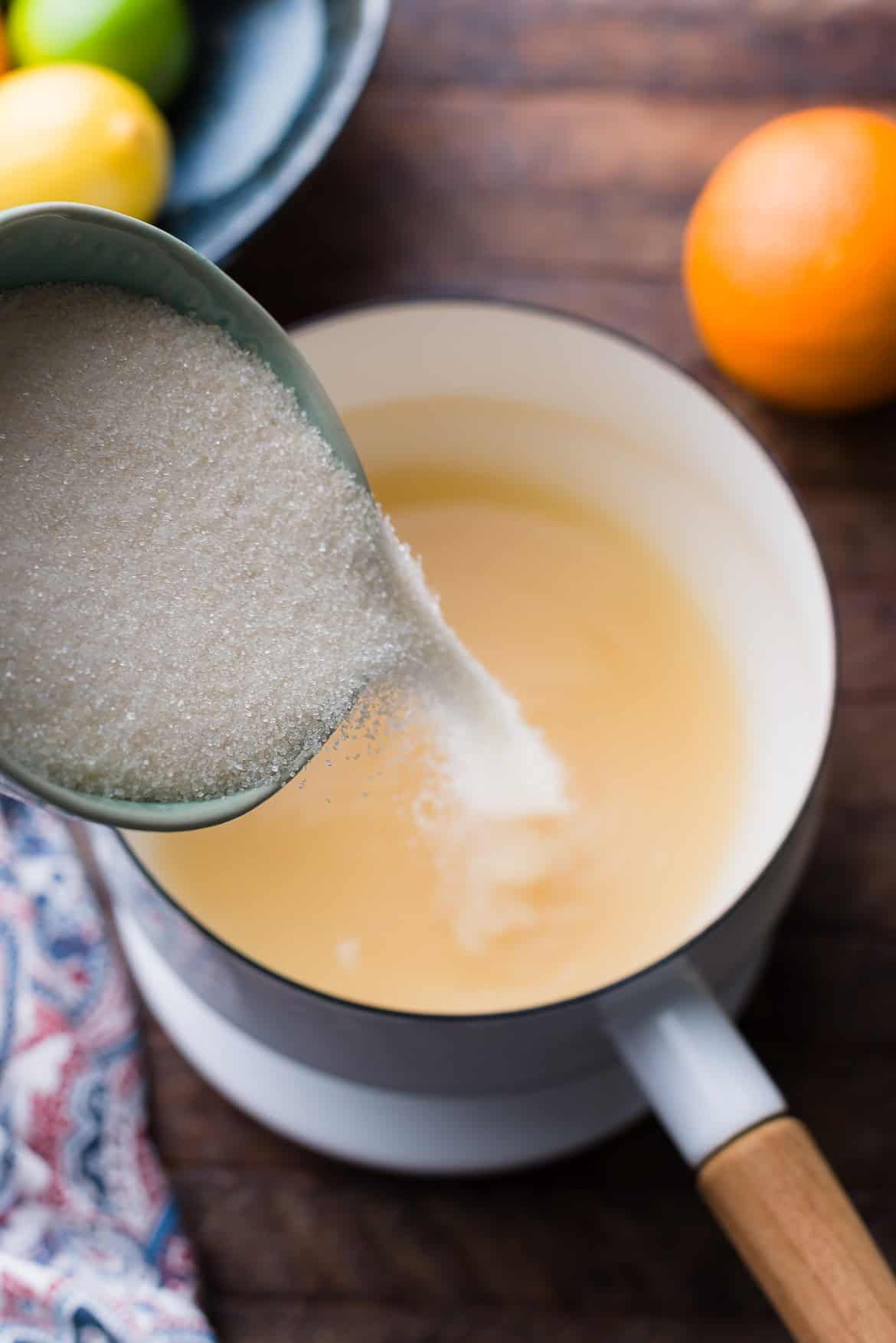 Making sugar syrup to candy citrus peel.