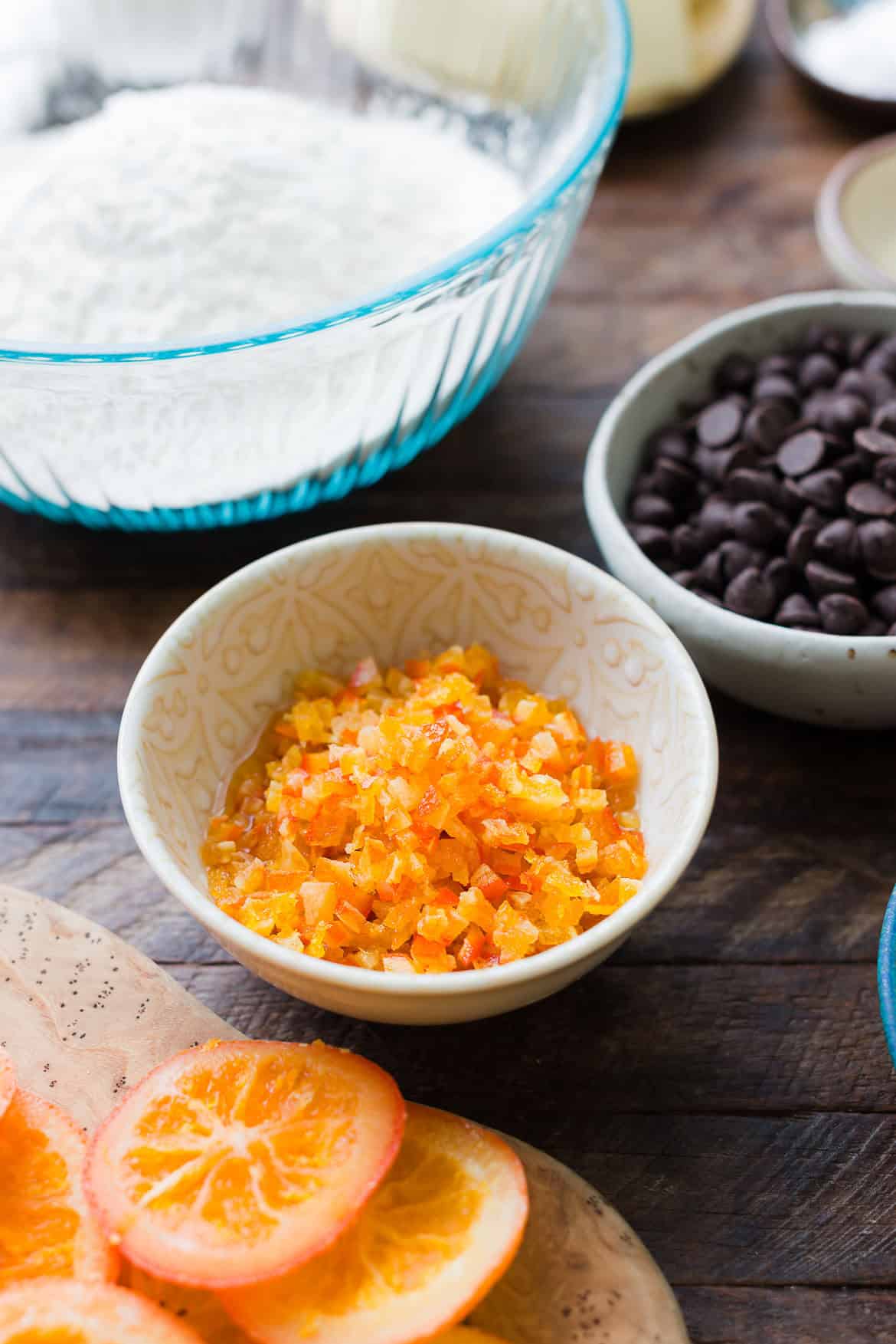 Macerating finely chopped dried orange slices in Grand Marnier (orange liqueur) for chocolate orange cookies.