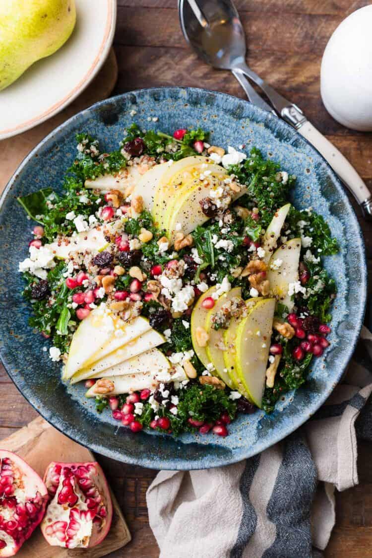 Kale salad with quinoa, pears, feta, pomegranate aerils, and walnuts.