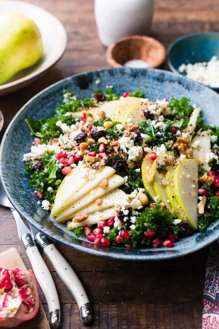Kale and Quinoa Fall Salad with Pears in a blue bowl.