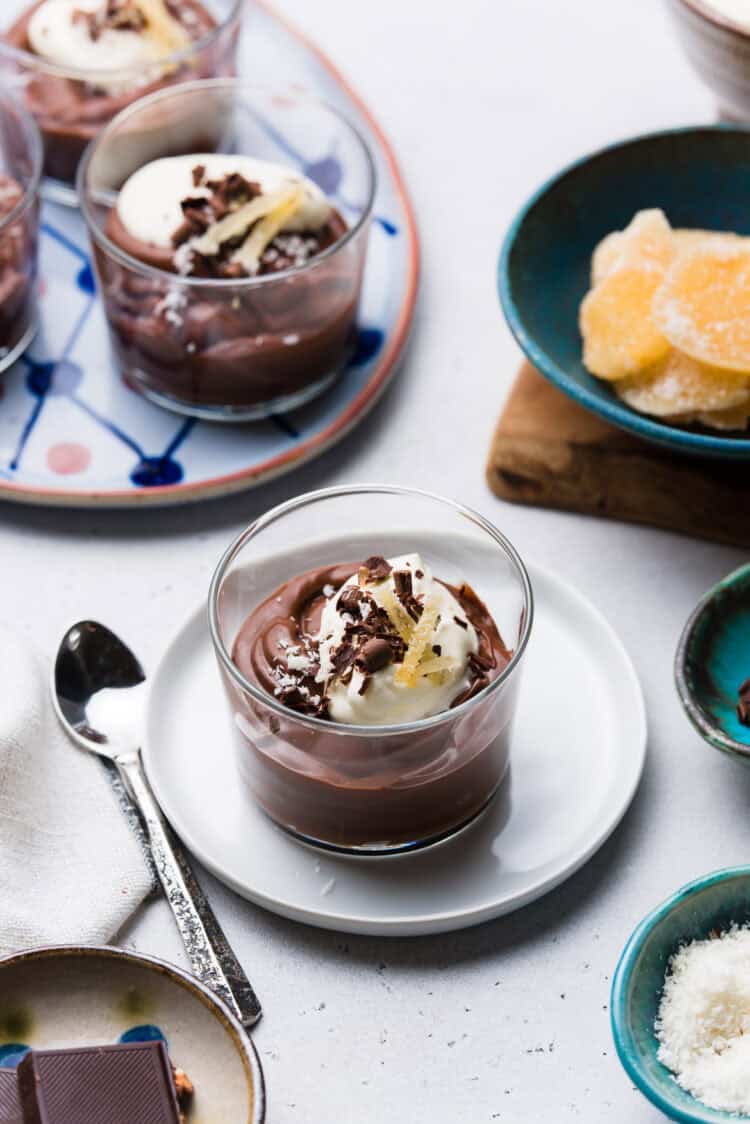 Coconut Chocolate Pudding garnished with chocolate shavings, coconut, and crystalized ginger.