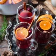 Traditional wassail garnished with oranges, cranberries, and cinnamon.