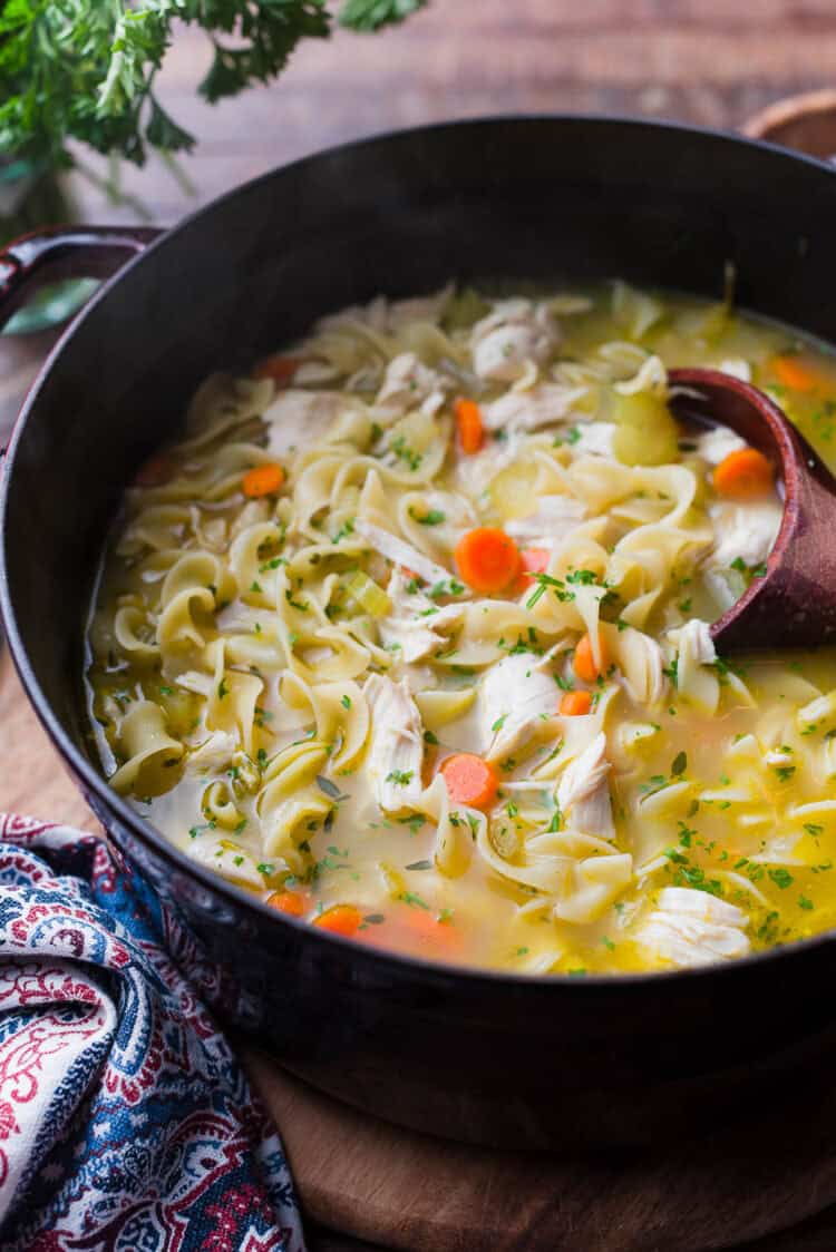 A large pot of chicken noodle soup.