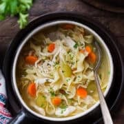 A bowl of simple chicken noodle soup.