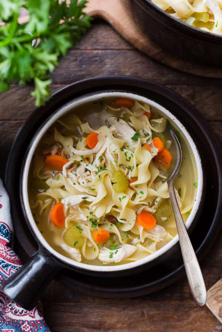A bowl of simple chicken noodle soup.