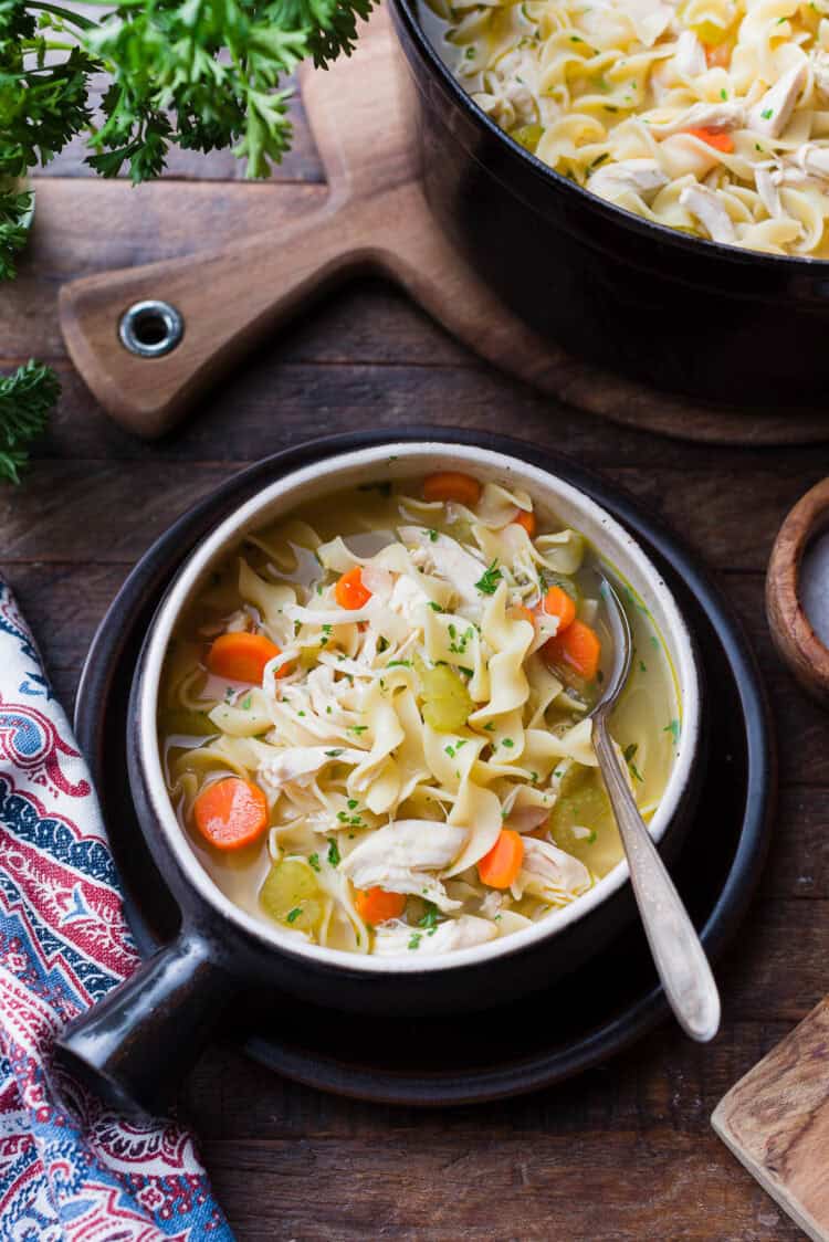 A simple chicken noodle soup in a bowl.