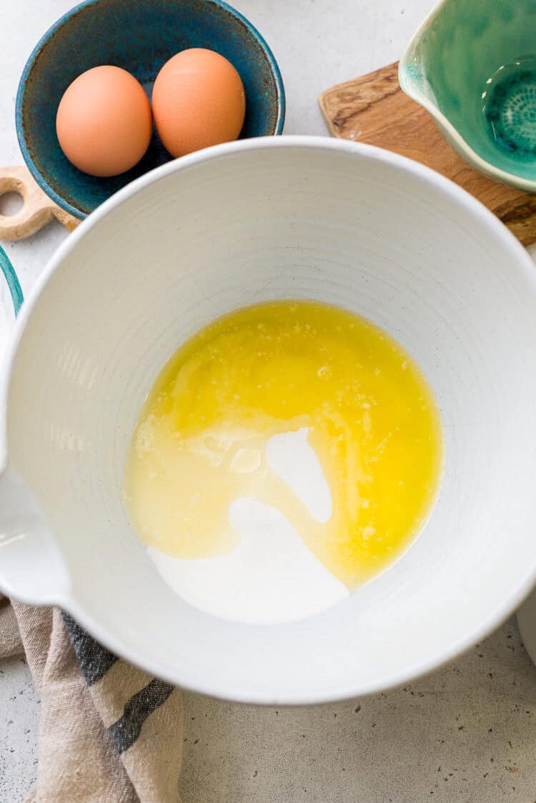 Granulated sugar and melted butter in a bowl.
