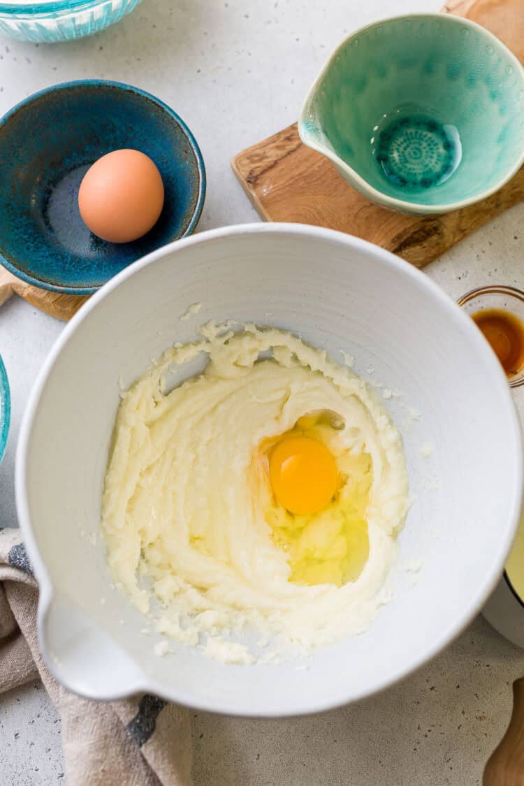 Adding eggs to ube crinkle cookies batter.