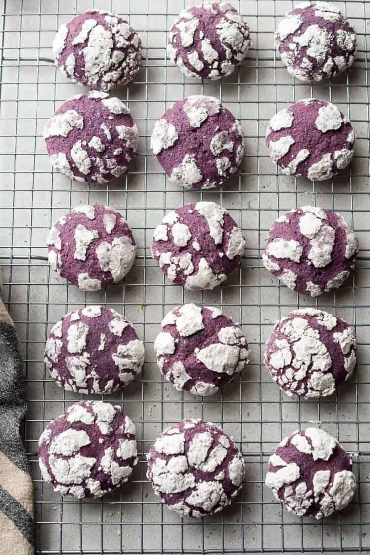 Ube Crinkle Cookies on a wire rack.