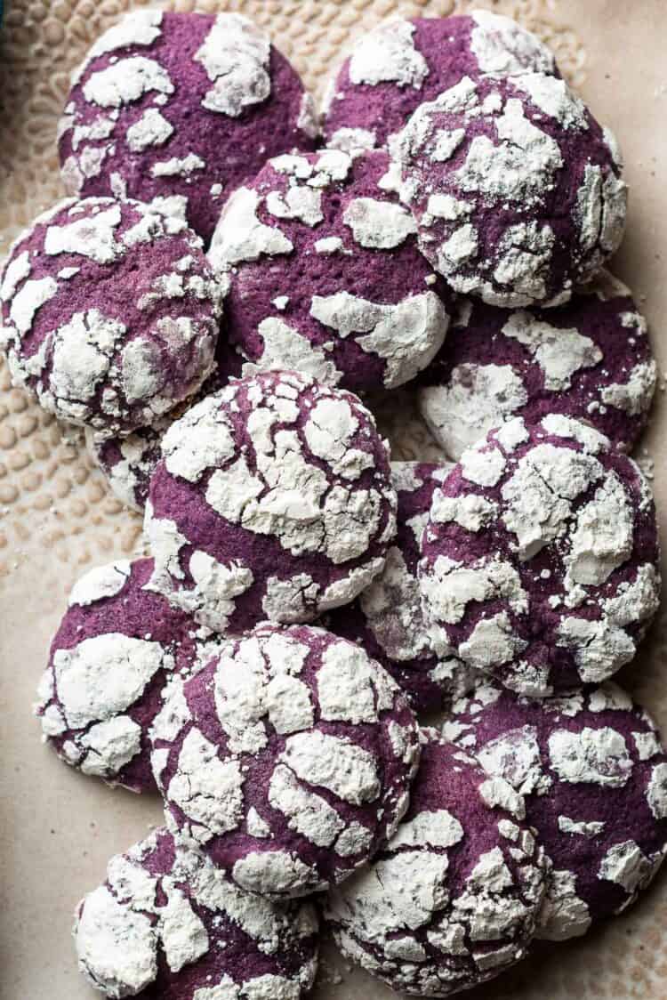 Ube Crinkle Cookies piled on a tray.