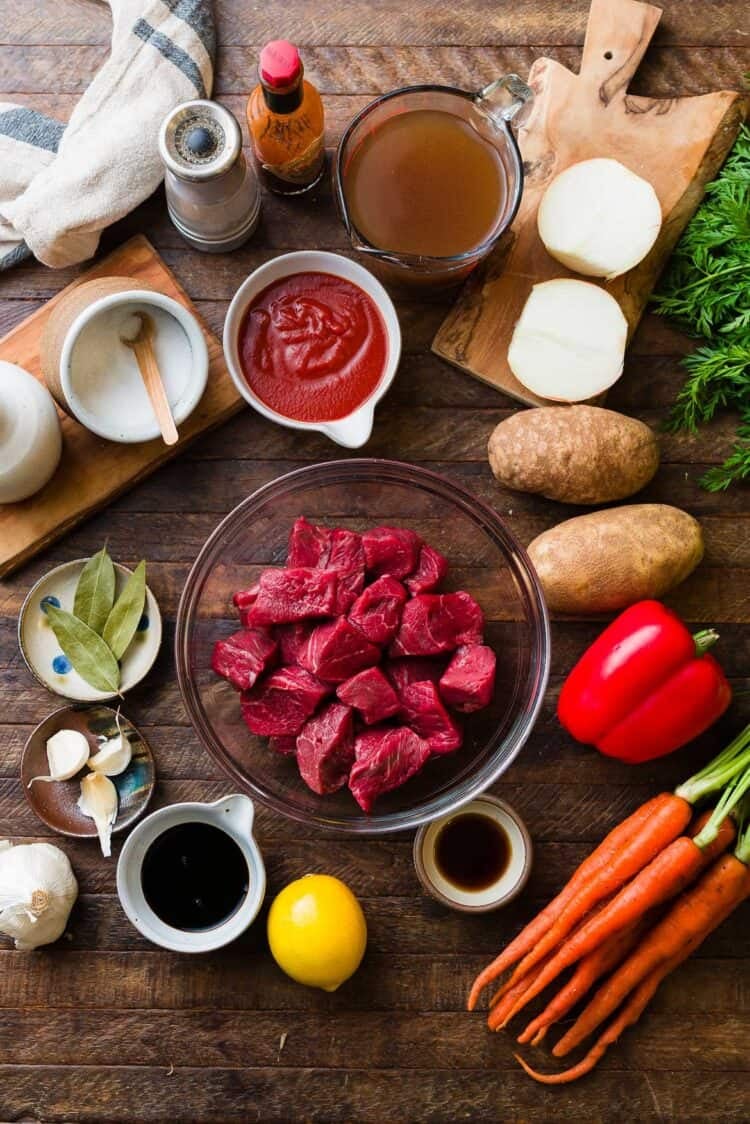 Ingredients for Mechado, a Filipino beef stew: beef, potatoes, carrots, red bell pepper, soy sauce, fish sauce, lemon, garlic, bay leaves, onion, beef broth, tomato sauce, Tabasco, salt, and pepper.