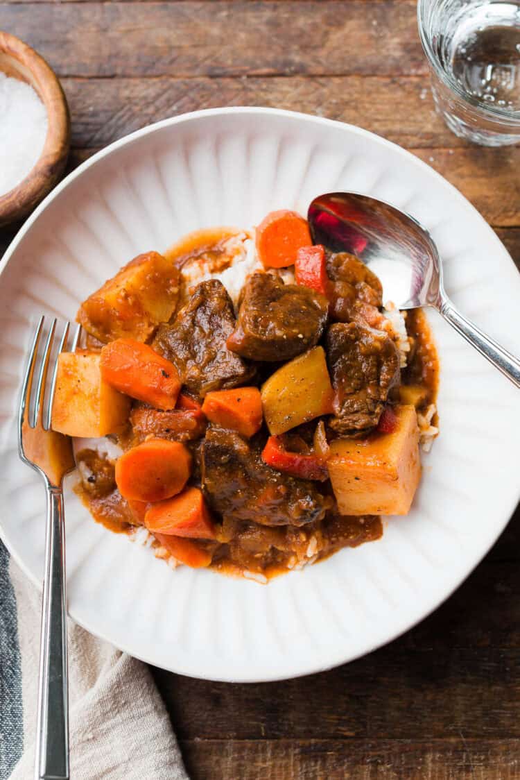 Mechado (Filipino Beef Stew) served in a white bowl, with white rice.