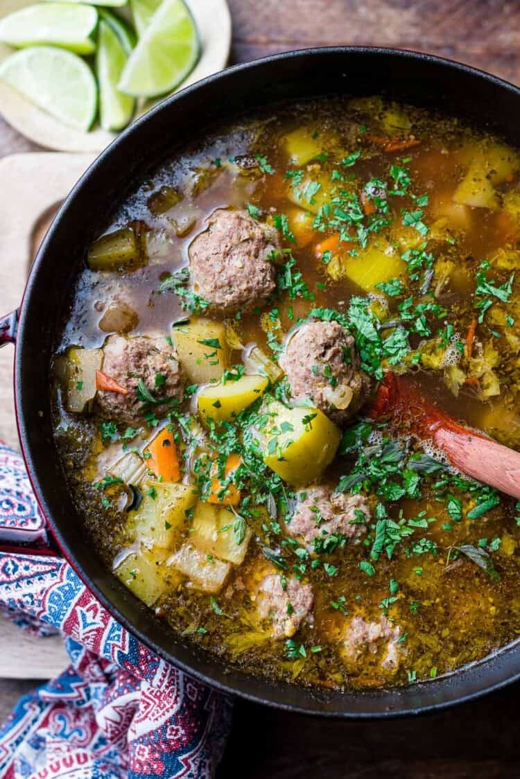 Albondigas (Mexican meatball soup) in a pot: beef meatballs with potatoes, chayote, zucchini, and fresh herbs.